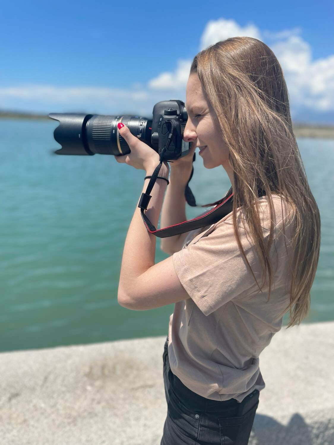 Fotograf trzymający kamerę z obiektywem